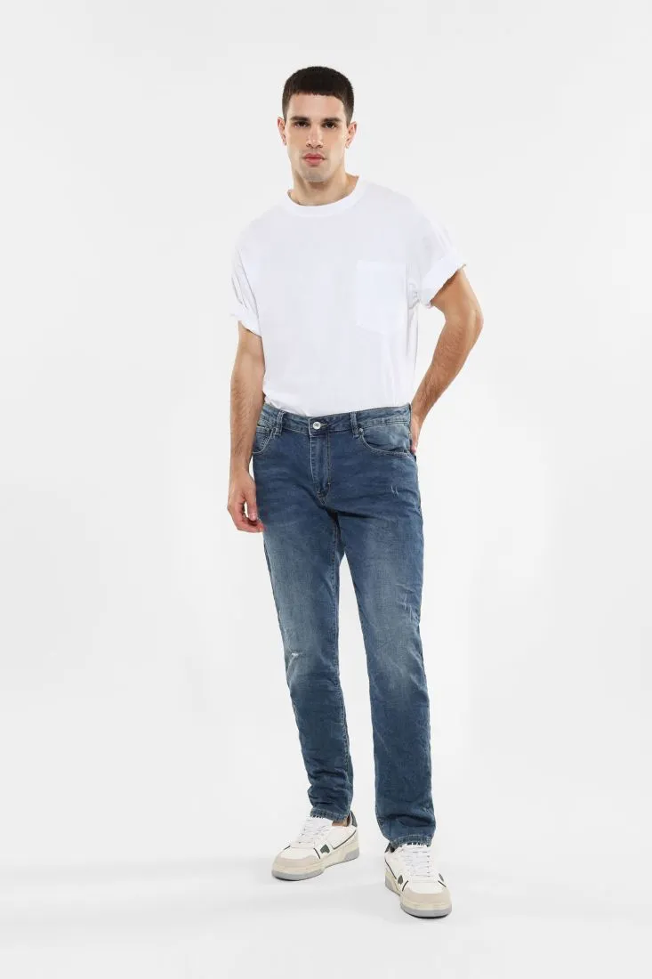 Jeans slim-fit effetto délavé con abrasioni