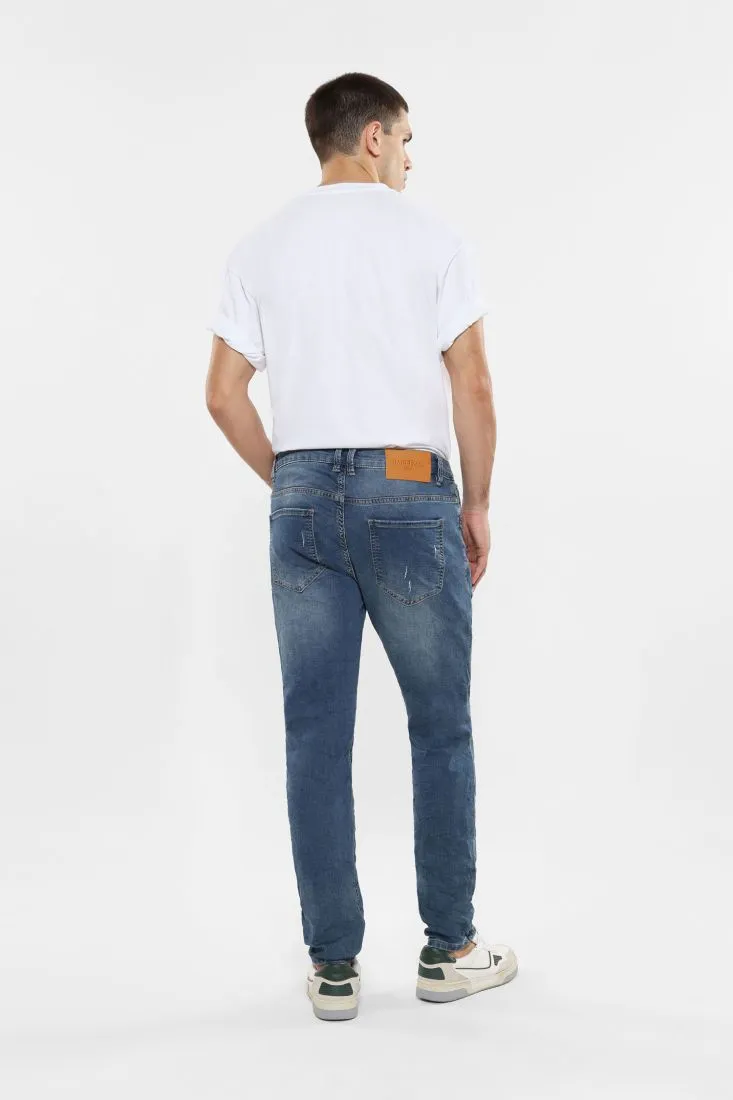 Jeans slim-fit effetto délavé con abrasioni